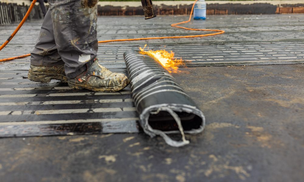 Bituminous membrane waterproofing system details and installation on flat rooftop.